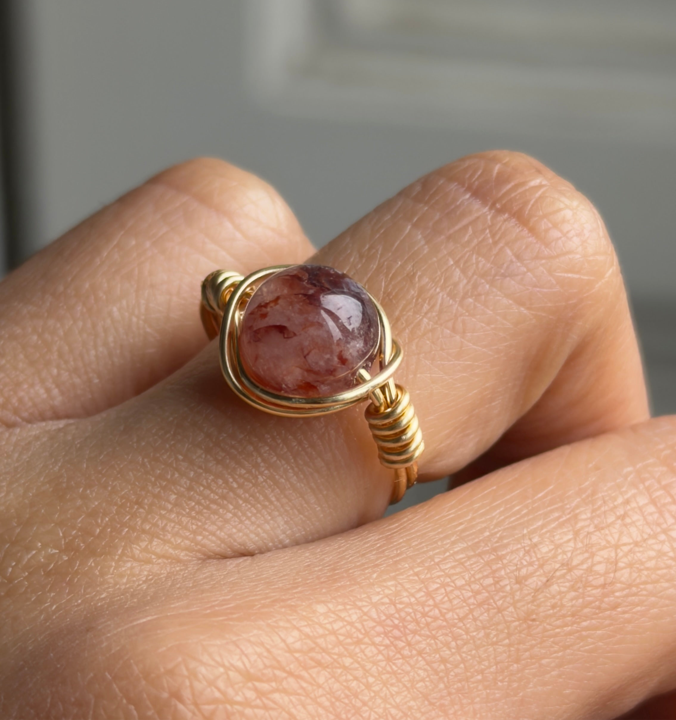 Handmade wire-wrapped ring with natural strawberry quartz. Adjustable fit and custom sizing available. A bold yet elegant statement piece.